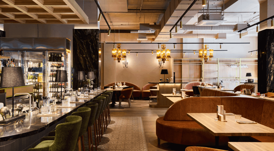 Upscale dining area with plush seating and elegant lighting.
